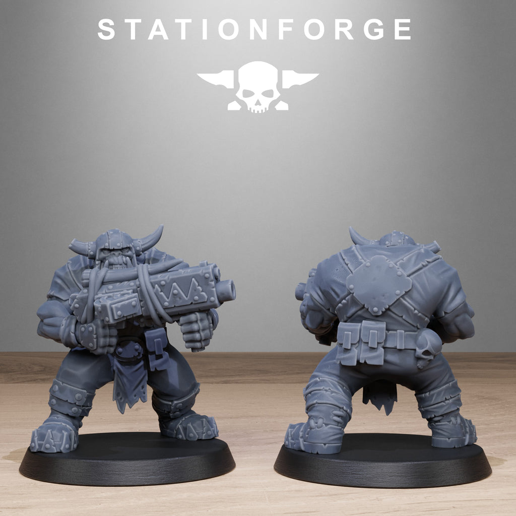 Two gray miniature figures on black bases with 'Stationforge' branding in the background.