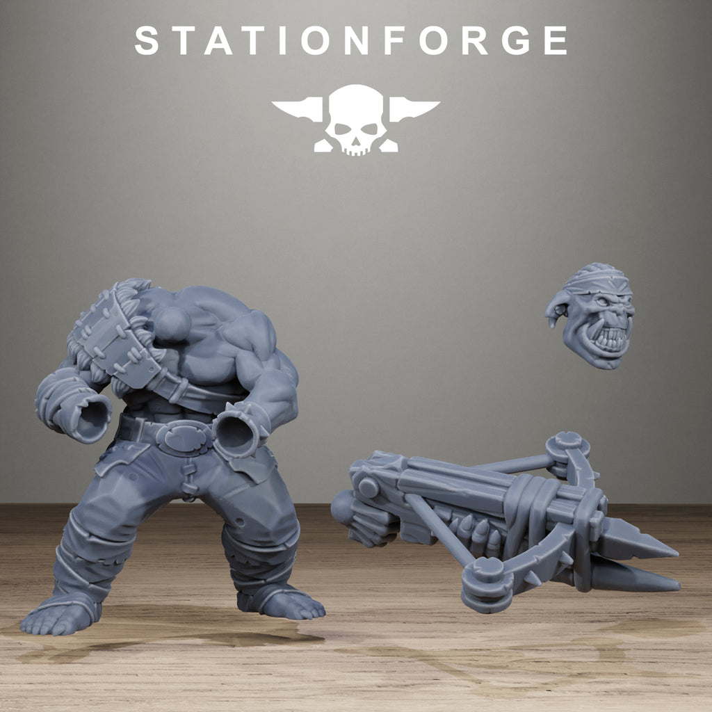 Gray figurine of a muscular character with crossbow and helmet on a wooden surface, Stationforge logo above.