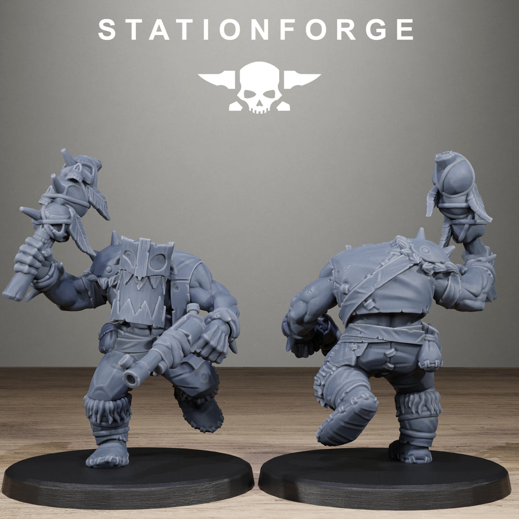 Two gray miniature figures on black bases with 'Stationforge' logo above.