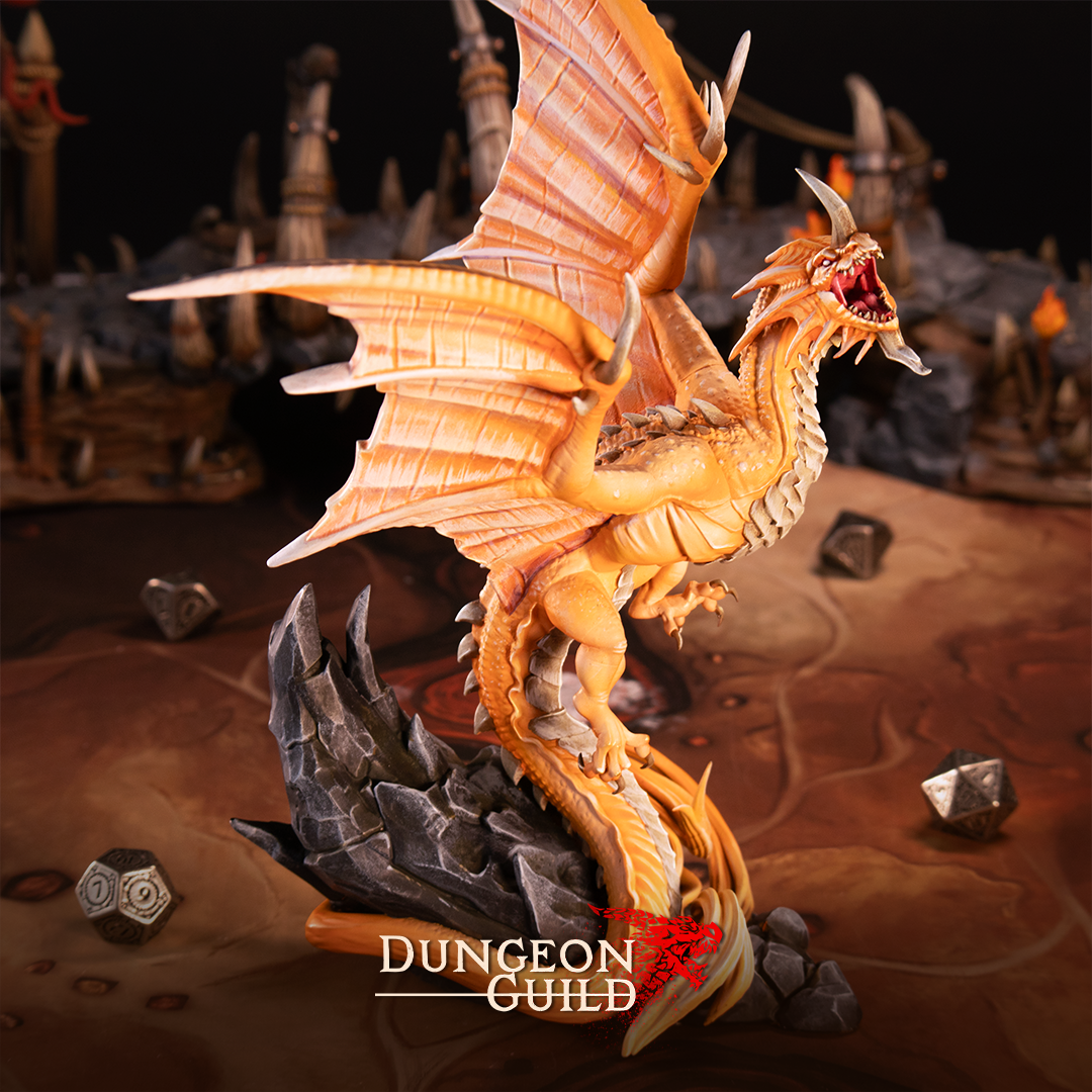 Painted resin Sylvarix Radiant Dragon miniature for D&D and tabletop RPG, showcasing the huge dragon model in warm golden tones on a detailed gaming table with dice for scale.
